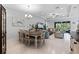 Open-concept living and dining area with modern lighting, neutral decor, and access to the outdoors at 1121 Avery Meadows Way, Deland, FL 32724