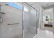 This primary bathroom has a frameless shower with a handheld shower head and access to the primary bedroom at 1121 Avery Meadows Way, Deland, FL 32724