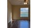 Cozy bedroom featuring wood-look floors, a large window, and neutral wall colors for a relaxing retreat at 117 Stewart Lake Loop, Groveland, FL 34736