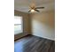 Bedroom features a large window and a ceiling fan at 117 Stewart Lake Loop, Groveland, FL 34736