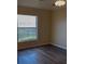 Bright bedroom with a large window and modern ceiling fan at 117 Stewart Lake Loop, Groveland, FL 34736