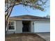 Charming single-story home with a two-car garage, freshly painted, and well-maintained landscaping at 117 Stewart Lake Loop, Groveland, FL 34736