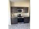 Well-equipped kitchen featuring stainless steel appliances, granite countertops, and ample cabinet space at 117 Stewart Lake Loop, Groveland, FL 34736