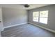 Bright bedroom featuring new flooring and a large window offering natural light at 1200 Jarecki Ave, Holly Hill, FL 32117