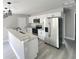 Well-lit kitchen featuring stainless steel appliances, white cabinets and a granite countertop at 1200 Jarecki Ave, Holly Hill, FL 32117