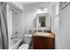 Well-lit bathroom featuring a classic vanity, mirror, and shower at 1207 Rich Moor Cir, Orlando, FL 32807