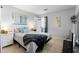 Light-filled bedroom with tile floors, a bed with blue pillows, and modern decor at 1207 Rich Moor Cir, Orlando, FL 32807