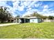 Charming single-story home featuring an inviting covered entry and a well-maintained lawn under a sunny sky at 1207 Rich Moor Cir, Orlando, FL 32807