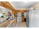 Bright kitchen featuring tile floors, wood cabinets, stainless steel refrigerator, and backyard views at 1207 Rich Moor Cir, Orlando, FL 32807