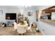 Open living and dining area featuring tile flooring, a large TV, and views of the kitchen at 1207 Rich Moor Cir, Orlando, FL 32807