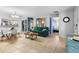 Cozy living room featuring a comfortable sofa, tile floors, and an open layout to the kitchen at 1207 Rich Moor Cir, Orlando, FL 32807