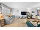 Bright living room featuring tile floors, a daybed, and neutral walls with colorful accents at 1207 Rich Moor Cir, Orlando, FL 32807