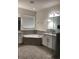Bright bathroom featuring a soaking tub, double vanity, and granite countertops at 12126 Homestead Park Ln, Orlando, FL 32824