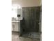 Modern bathroom featuring a glass shower enclosure, neutral tile, and a spacious double vanity at 12126 Homestead Park Ln, Orlando, FL 32824