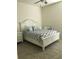 Comfortable bedroom features a bed, end table, and mirror at 12126 Homestead Park Ln, Orlando, FL 32824