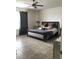 Spacious bedroom with a ceiling fan, tile floors, and a luxurious bed with decorative pillows at 12126 Homestead Park Ln, Orlando, FL 32824