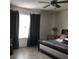 Well-lit bedroom features a ceiling fan, window, and a comfortable bed with decorative pillows at 12126 Homestead Park Ln, Orlando, FL 32824