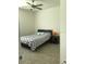 Bright bedroom featuring a ceiling fan, tile floors, and a bed with stylish chevron-patterned bedding at 12126 Homestead Park Ln, Orlando, FL 32824