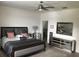 Open bedroom featuring tile floors, a ceiling fan, and stylish furnishings including a dresser and king bed at 12126 Homestead Park Ln, Orlando, FL 32824
