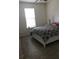 A comfortable bedroom featuring neutral colors, a patterned bedspread, and ample natural light at 12126 Homestead Park Ln, Orlando, FL 32824