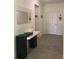 Bright foyer with tile flooring and a decorative console table with a mirror at 12126 Homestead Park Ln, Orlando, FL 32824