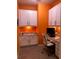 Bright home office with white cabinetry, granite countertop, and orange accent wall at 12126 Homestead Park Ln, Orlando, FL 32824