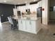 Spacious kitchen with a large island featuring granite countertops, white cabinets, and stainless steel appliances at 12126 Homestead Park Ln, Orlando, FL 32824