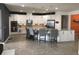 Bright kitchen features white cabinets, stainless steel appliances, granite countertops, and a large island with bar seating at 12126 Homestead Park Ln, Orlando, FL 32824