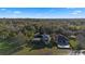 Expansive aerial view of two beautiful homes surrounded by lush green trees under a bright blue sky at 1320 Myrtle Dr, Longwood, FL 32750