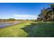 Backyard view of the grassy land near the water with trees surrounding the area at 1320 Myrtle Dr, Longwood, FL 32750