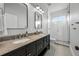 Bathroom features a double vanity, modern fixtures, large mirror, and walk-in shower with pebble floor at 1320 Myrtle Dr, Longwood, FL 32750