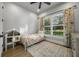 Bright bedroom features a daybed, floral curtains, and a window with outdoor views at 1320 Myrtle Dr, Longwood, FL 32750