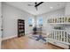Bedroom features hardwood floors, a ceiling fan, windows, and a bunk bed with a work desk at 1320 Myrtle Dr, Longwood, FL 32750