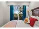 Bright bedroom with a view of the pool and tropical landscaping through the large window at 1320 Myrtle Dr, Longwood, FL 32750