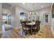 Dining room with seating for eight, bright light fixture, and large windows for backyard views at 1320 Myrtle Dr, Longwood, FL 32750