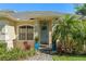 Inviting home exterior featuring a decorative front door, lush landscaping, and a brick walkway, with blue accents at 1320 Myrtle Dr, Longwood, FL 32750