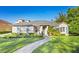 Charming single-story home with a well-manicured lawn and inviting walkway at 1320 Myrtle Dr, Longwood, FL 32750