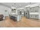 Bright kitchen boasts gray cabinets, granite counters, stainless appliances, and large center island with seating at 1320 Myrtle Dr, Longwood, FL 32750
