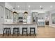 This light and airy kitchen features gray cabinets, granite countertops and island seating for four at 1320 Myrtle Dr, Longwood, FL 32750