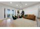 Living room with modern décor, filled with natural light from the french doors to the lanai at 1320 Myrtle Dr, Longwood, FL 32750
