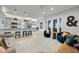 Open-concept living room featuring a kitchen, neutral furniture, and outdoor access at 1320 Myrtle Dr, Longwood, FL 32750