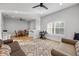 Light filled living room features hardwood floors, neutral colors, modern ceiling fan, and an area rug at 1320 Myrtle Dr, Longwood, FL 32750