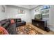 Cozy living room featuring a comfortable leather couch and decorative area rug at 1320 Myrtle Dr, Longwood, FL 32750