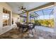 Covered patio with stone flooring, ceiling fan, and dining table with a view of the pool at 1320 Myrtle Dr, Longwood, FL 32750