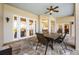 Covered outdoor dining area featuring a stone patio, ceiling fan, and views of the pool area at 1320 Myrtle Dr, Longwood, FL 32750