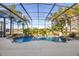 Luxurious screened-in pool area with a rock waterfall and lush tropical landscaping at 1320 Myrtle Dr, Longwood, FL 32750