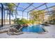 Beautiful pool area featuring a pool with a waterfall and a screened-in enclosure with lush landscaping at 1320 Myrtle Dr, Longwood, FL 32750