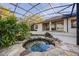 The backyard features a rock waterfall with lush greenery surrounding a screened-in lanai and pool at 1320 Myrtle Dr, Longwood, FL 32750