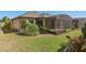 Home's manicured lawn and lush landscaping accentuate the private backyard, with the screened lanai offering shade at 1392 Zeek Ridge St, Clermont, FL 34715