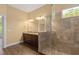 Well-lit bathroom with granite countertops, double sinks, glass-enclosed tiled shower at 1392 Zeek Ridge St, Clermont, FL 34715